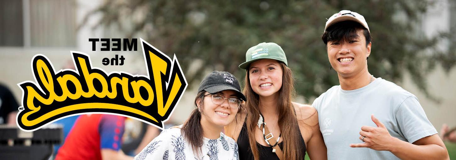 Three U of I students smiling at the camera